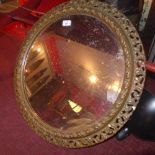 A circular wall mirror with a bevelled plate and gilt frame with acanthus leaf decoration.