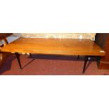 A retro 1950's Meredew walnut low table the rectangular top raised on black tapering supports