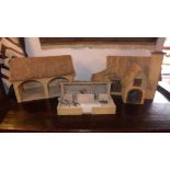 A collection of children's model farmyard barns and animals.