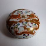 A Chinese famille rose porcelain ink pot decorated with two dragons chasing a pearl