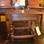 An antique oak joint stool raised on stretchered supports