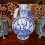 A Chinese blue and white porcelain vase with twin handles and pictorial reserves depicting a lady