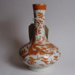 A Chinese porcelain vase decorated with a red dragon chasing a pearl