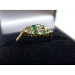 A 1930's 18ct yellow gold ladies ring inset with emeralds and diamonds