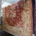 A Ziegler style rug decorated with palmettes on a red ground surrounded by borders, 190cm x 140cm.