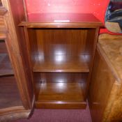 A Victorian walnut open bookcase with adjustable shelves raised on plinth base.