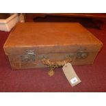 A vintage tan leather briefcase.