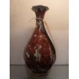 A Chinese vase with faceted sides, having underglaze floral decoration.