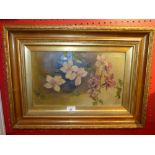 An early 20th Century oil on canvas still life study of flowers in a gilded frame