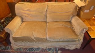 A late 19th century two seater sofa upholstered in velour and raised on castors.