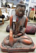 A 20th century red lacquer seated Buddha in meditative pose,