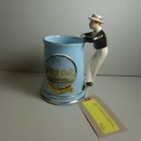 An Eton musical jug 'The Eton Boating Song' with figural handle and Eton landscape scenes in relief