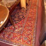 A small hand knotted runner the brown fields with repeating geometric decoration