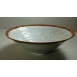 A Chinese celadon bowl with incised decoration to the interior.