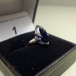 A 14ct white gold ring set 2.6ct Marquise sapphire and two 0.