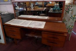 A G plan teak dressing table, having a long mirror over two sections of two short drawers.