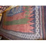 A fine South West Persian Qashgai Kilim rug with central medallion on a terracotta field within