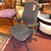 A black Herman Miller swivel office chair.