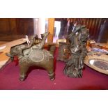 A collection of items including a bronze figure group, a carved soapstone figure,