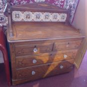 A Victorian painted pine chest, having a tiled gallery back over three long graduated drawers,