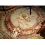 A pair of Chinese circular rugs, one having floral decoration on blue ground,