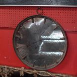 A vintage industrial style cast iron mirror with circular mirror plate