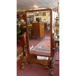 A William IV flame mahogany cheval mirror with bevelled plate in the swing frame.