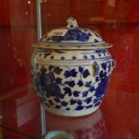 An antique Chinese blue and white lidded jar having floral reserves