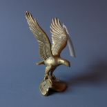 A cast brass figure of an eagle with its wings spread.