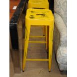 A set of four yellow industrial metal stools (4)