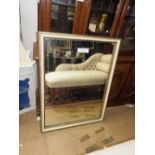 A Regency design parcel gilt and cream painted wall mirror,