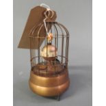 A small time piece in the form of a birdcage