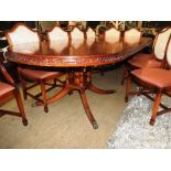 A reproduction mahogany twin pillar dining table with moulded edge and additional leaf,