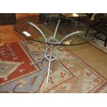 A silvered bamboo style conservatory table with glass top