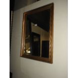 A contemporary wall mirror, the rectangular plate within leather clad box frame,