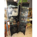 An early 20th Century Japanese black lacquer four fold screen with hand painted decoration