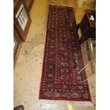 A signed Turkoman runner, the all over ivory geometric design on rouge ground,