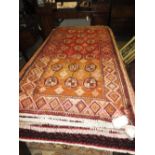A Turkoman rug, the all over geometric design on abrashed red and orange ground,