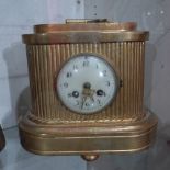 A Swedish giltwood mantel clock with circular enamel dial,