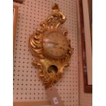 A Swedish carved giltwood Cartel clock with convex Roman numeral dial