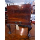 An early 19th century mahogany Chippendale design cellarette having rising lid and raised on ball