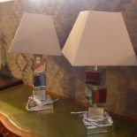 A pair of contemporary designer mirror glass table lamps of stacking form with shades