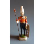 A Dresden porcelain figure 'Gentleman of Arms' heightened in gilt