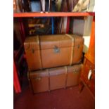 Two vintage leather and wood bound travelling trunks with twin handles