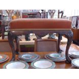 A 19th century Chippendale design walnut stool upholstered in salmon velour and raised on shell