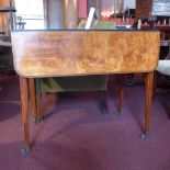 A George III satinwood and crossbanded Pembroke table having twin flaps and fitted end drawer