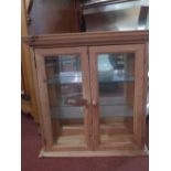 A vintage pine hanging cabinet fitted pair of glazed panel doors enclosing glass shelves