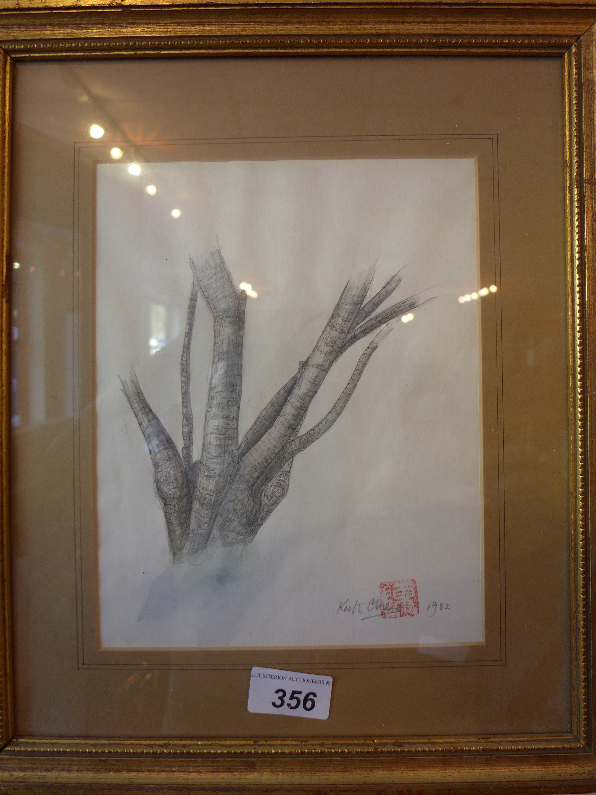 A glazed and framed watercolour study by K Cheng of a branch