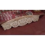 An antique carved pine and cream painted