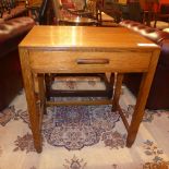 A circa 1940's oak side table with a sin